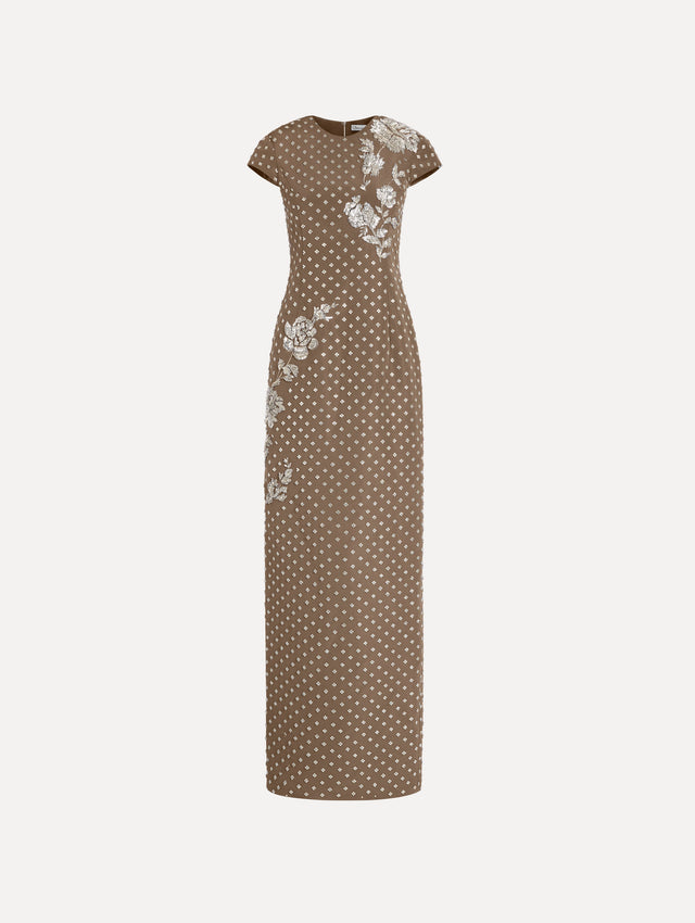 The model is wearing the crystal grid floral embroidered gown with short sleeves in the color stone.