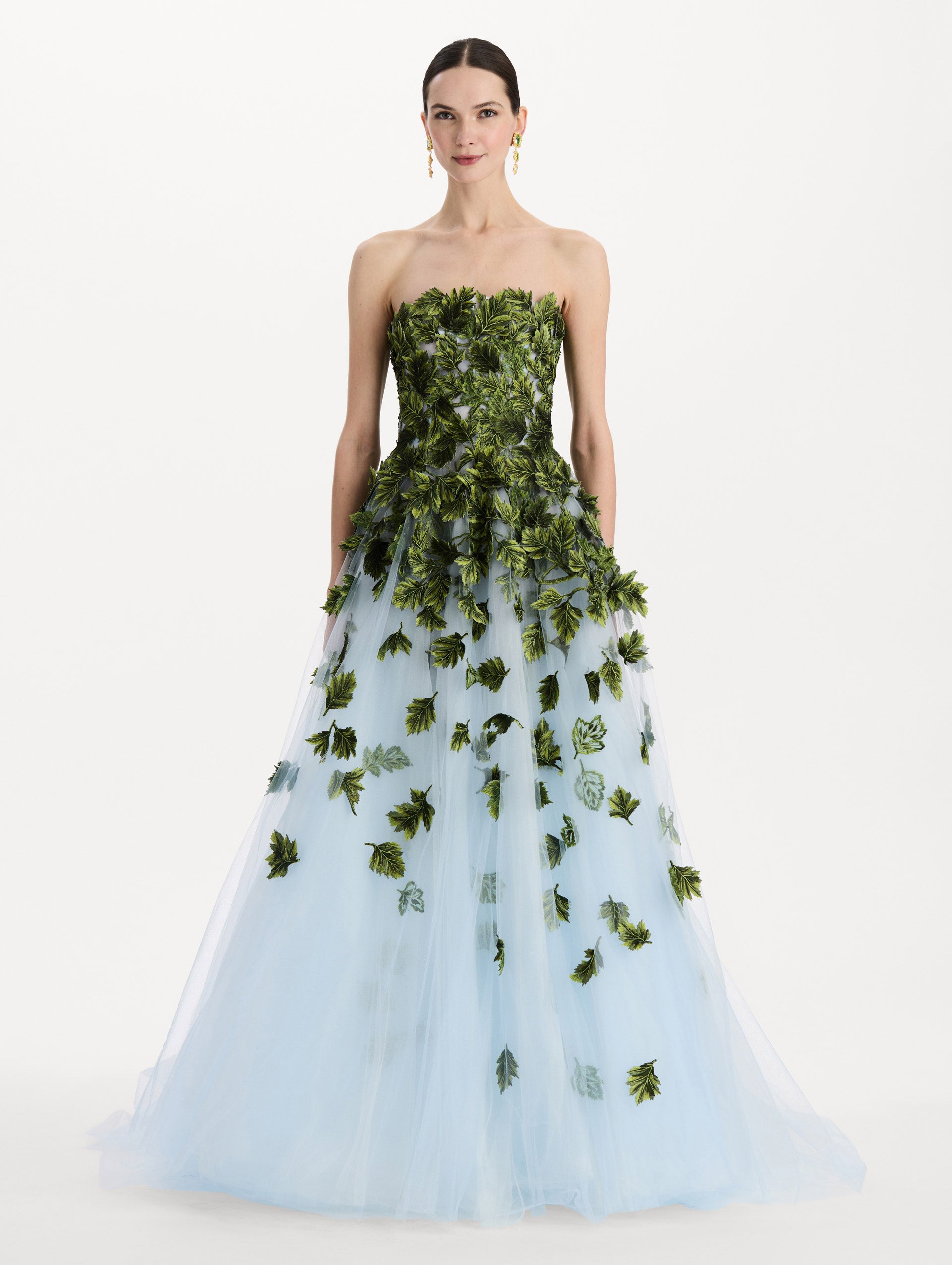 The model is wearing the maple leaf appliqué gown with a strapless silhouette in the color sky blue. Front view.