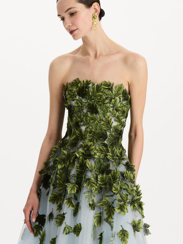 The model is wearing the maple leaf appliqué gown with a strapless silhouette in the color sky blue. Zoom view.