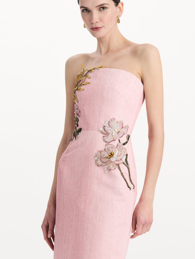 The model is wearing the beaded mixed botanical embroidered column gown with floral detailing and a strapless silhouette in the color blush. Zoom view.