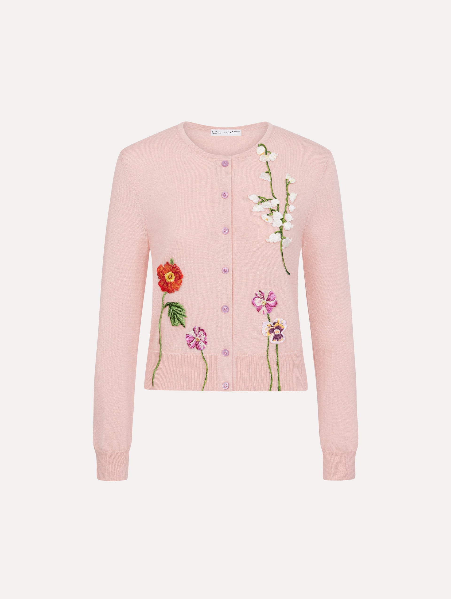 The model is wearing the mixed botanical threadwork cardigan in the color blush with floral detailing. 