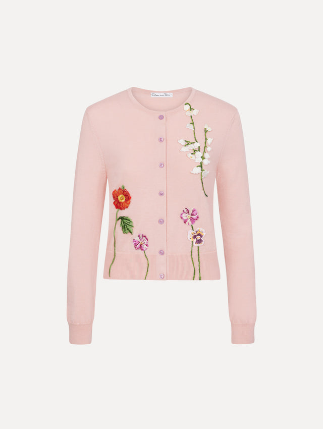 The model is wearing the mixed botanical threadwork cardigan in the color blush with floral detailing. 