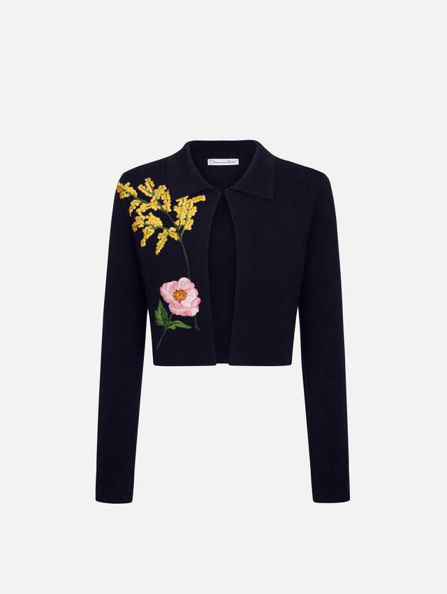 The model is wearing the mixed botanical cropped jacket with delicate embroidery in the color navy.