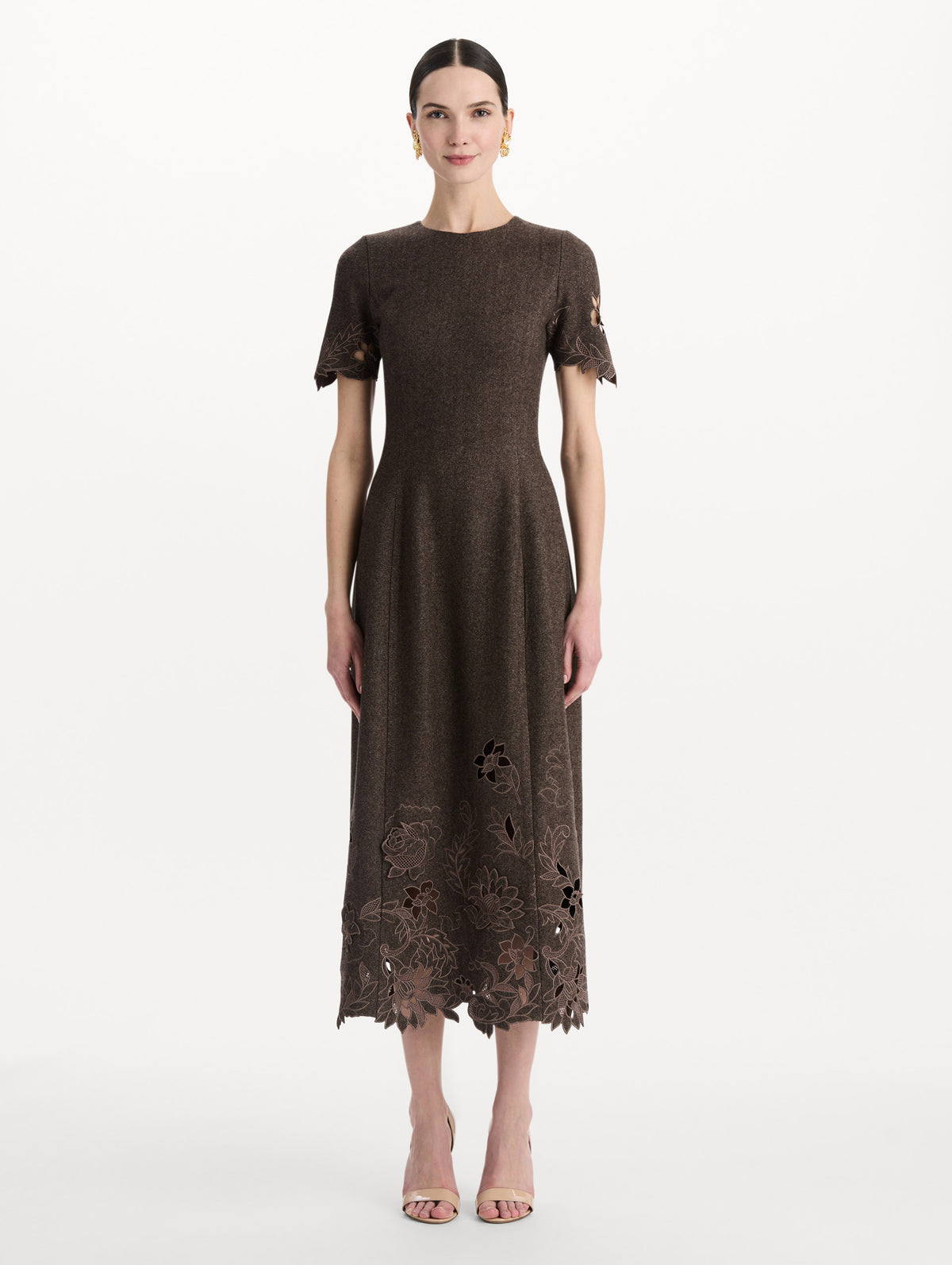 The model is wearing the peony cutout twill herringbone dress with short sleeves in a brown wool-cashmere blend. Front view.