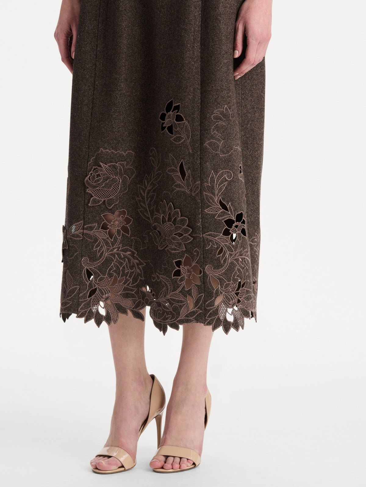The model is wearing the peony cutout twill herringbone dress with short sleeves in a brown wool-cashmere blend. Zoom view.