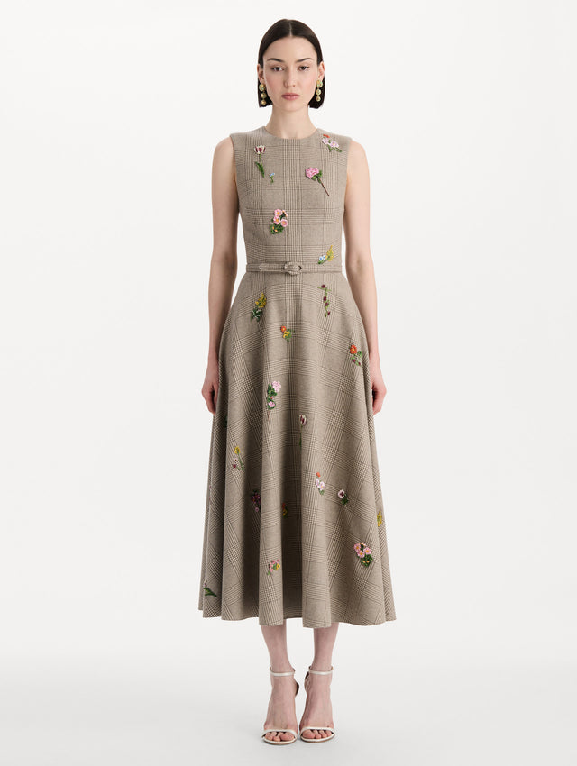 The model is wearing the plaid cashmere-blend dress with a sleeveless silhouette and a glen plaid pattern. Front view. 