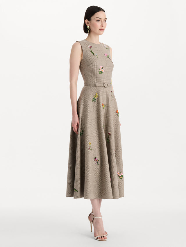 The model is wearing the plaid cashmere-blend dress with a sleeveless silhouette and a glen plaid pattern. Side view.