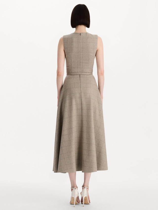 The model is wearing the plaid cashmere-blend dress with a sleeveless silhouette and a glen plaid pattern. Back view.