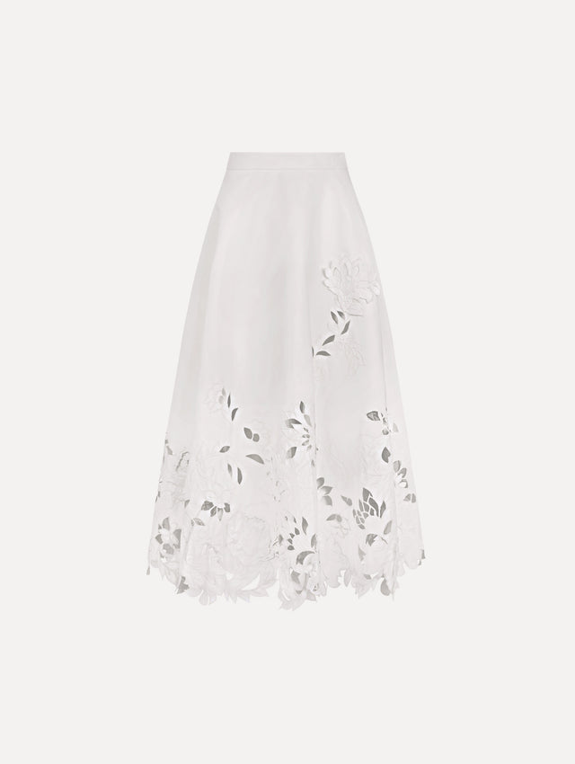 The model is wearing the floral cutout cotton twill skirt with botanical embroidery and a full silhouette in the color white.