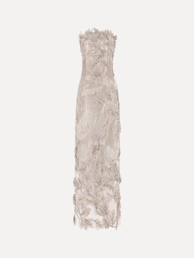The model is wearing the intarsia leaves cutout embroidered cocktail dress with a strapless silhouette in the color silver.