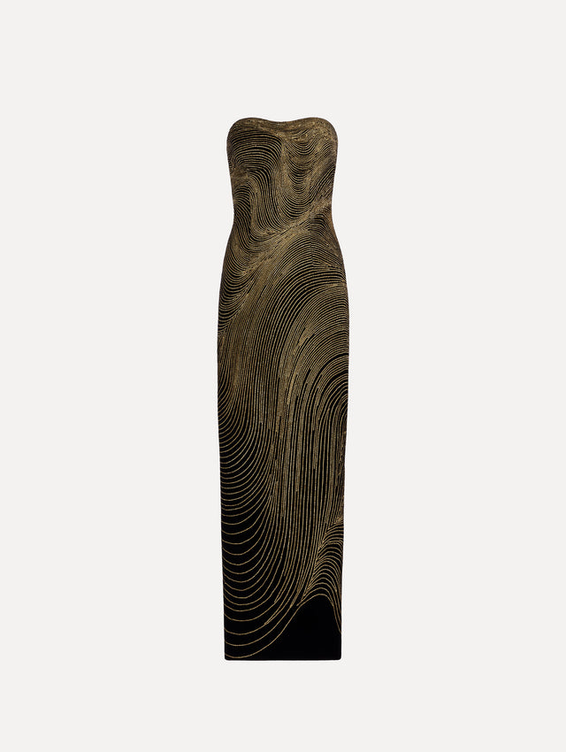 The model is wearing the beaded wave embroidered strapless cocktail dress in black and gold.