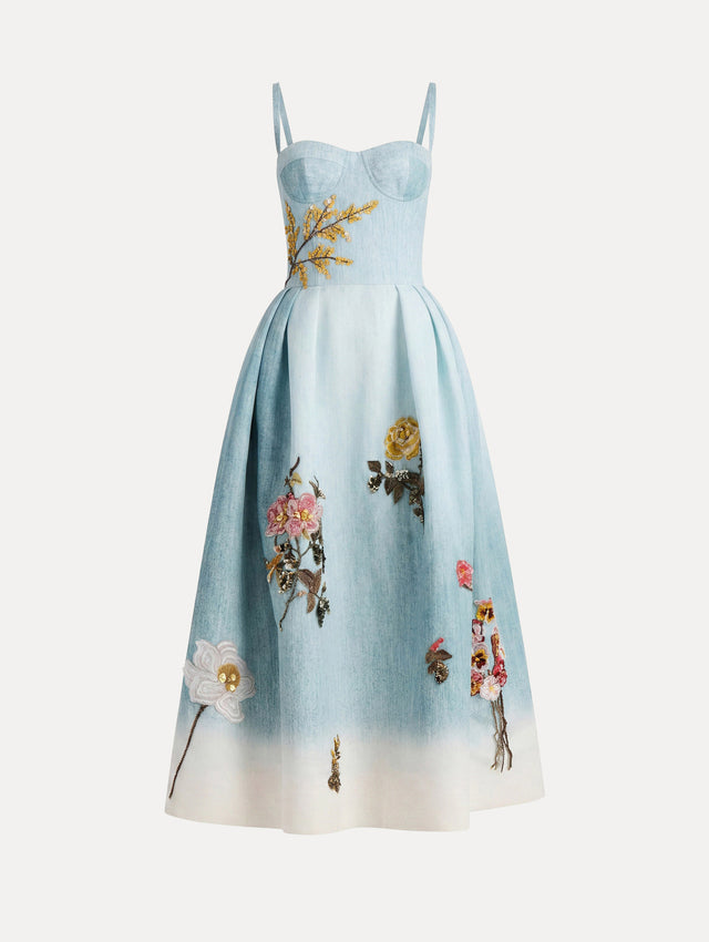 The model is wearing the beaded mixed botanical bustier dress with floral detailing and a sleeveless silhouette in blue multi. 