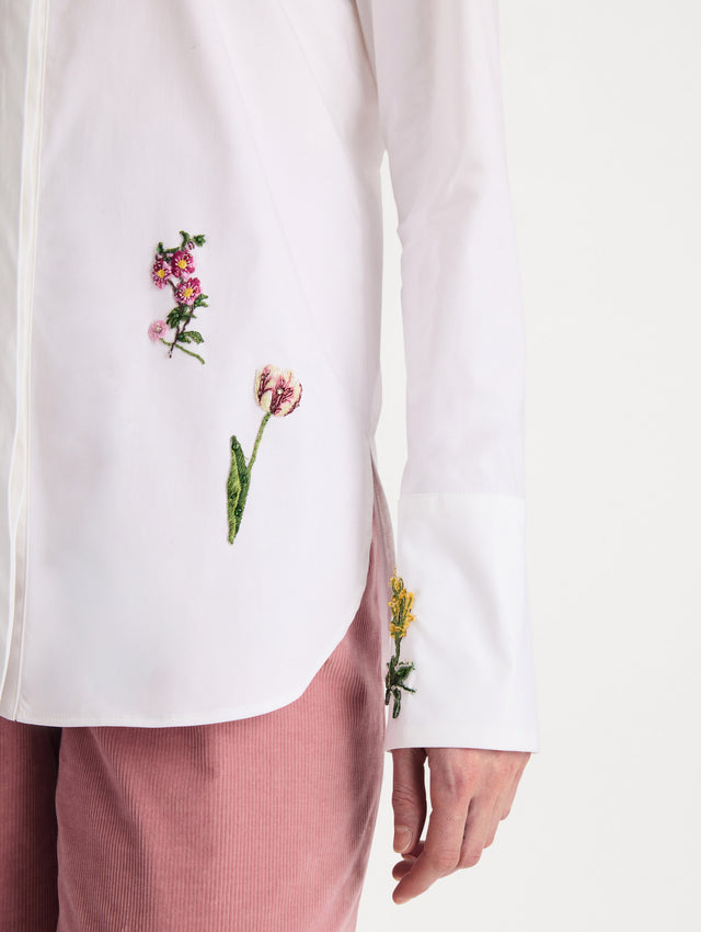 The model is wearing the beaded mixed botanical stretch twill blouse with long sleeves in the color white. Zoom View.