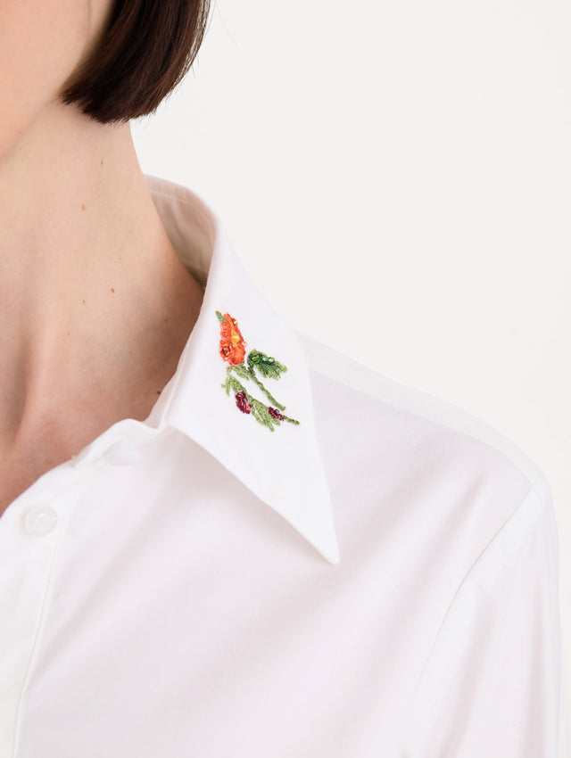 The model is wearing the beaded mixed botanical stretch twill blouse with long sleeves in the color white. Zoom View.