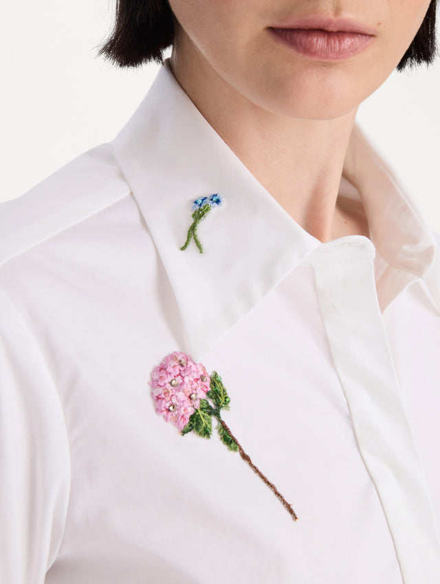 The model is wearing the beaded mixed botanical stretch twill blouse with long sleeves in the color white. Zoom View.