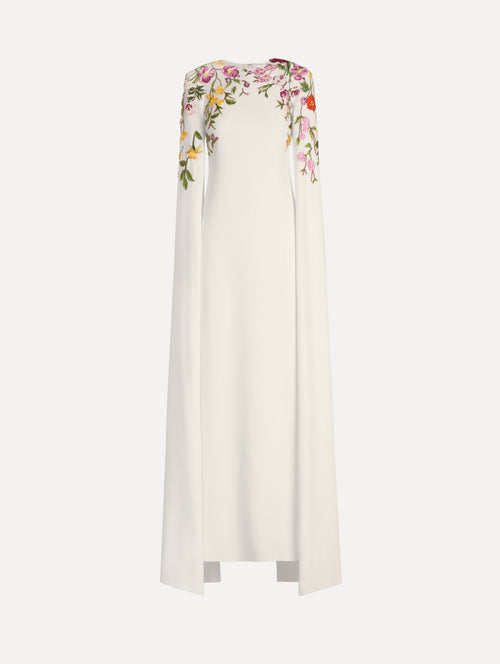 The model is wearing the mixed botanical embroidered georgette caftan with long sleeves in the color ivory.