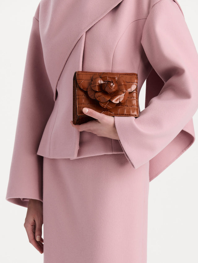The Embossed Mini TRO Bag in the color cognac. Front view. 