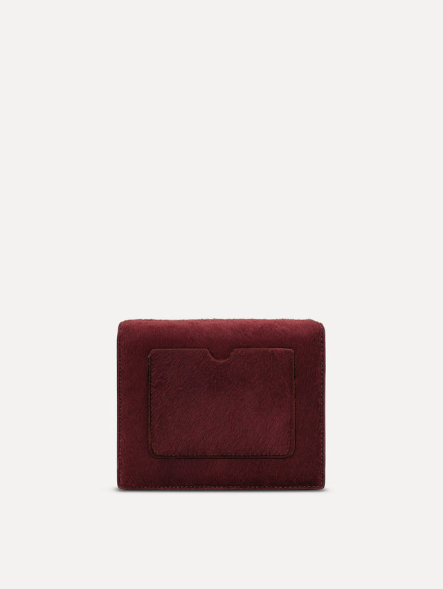 The Haircalf Mini TRO Bag in the color bordeaux. Back view.