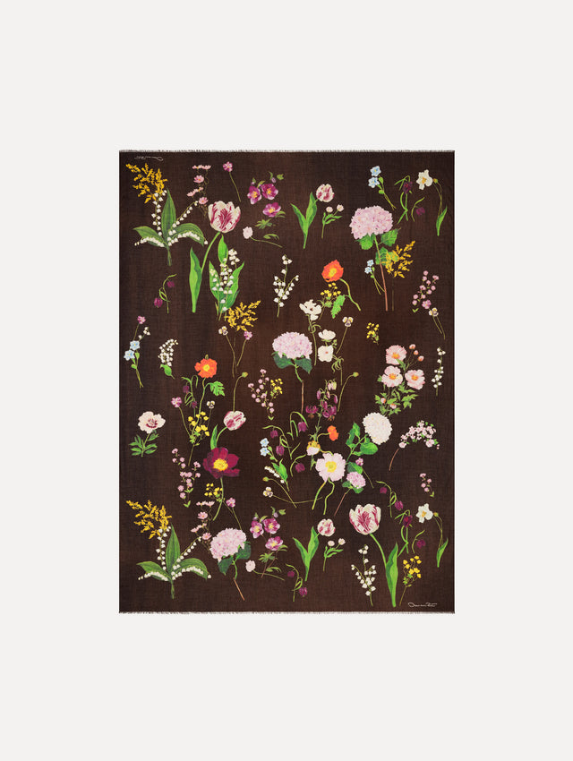 The model is wearing the mixed botanical scarf with an all-over floral print in the color brown. Full view. 