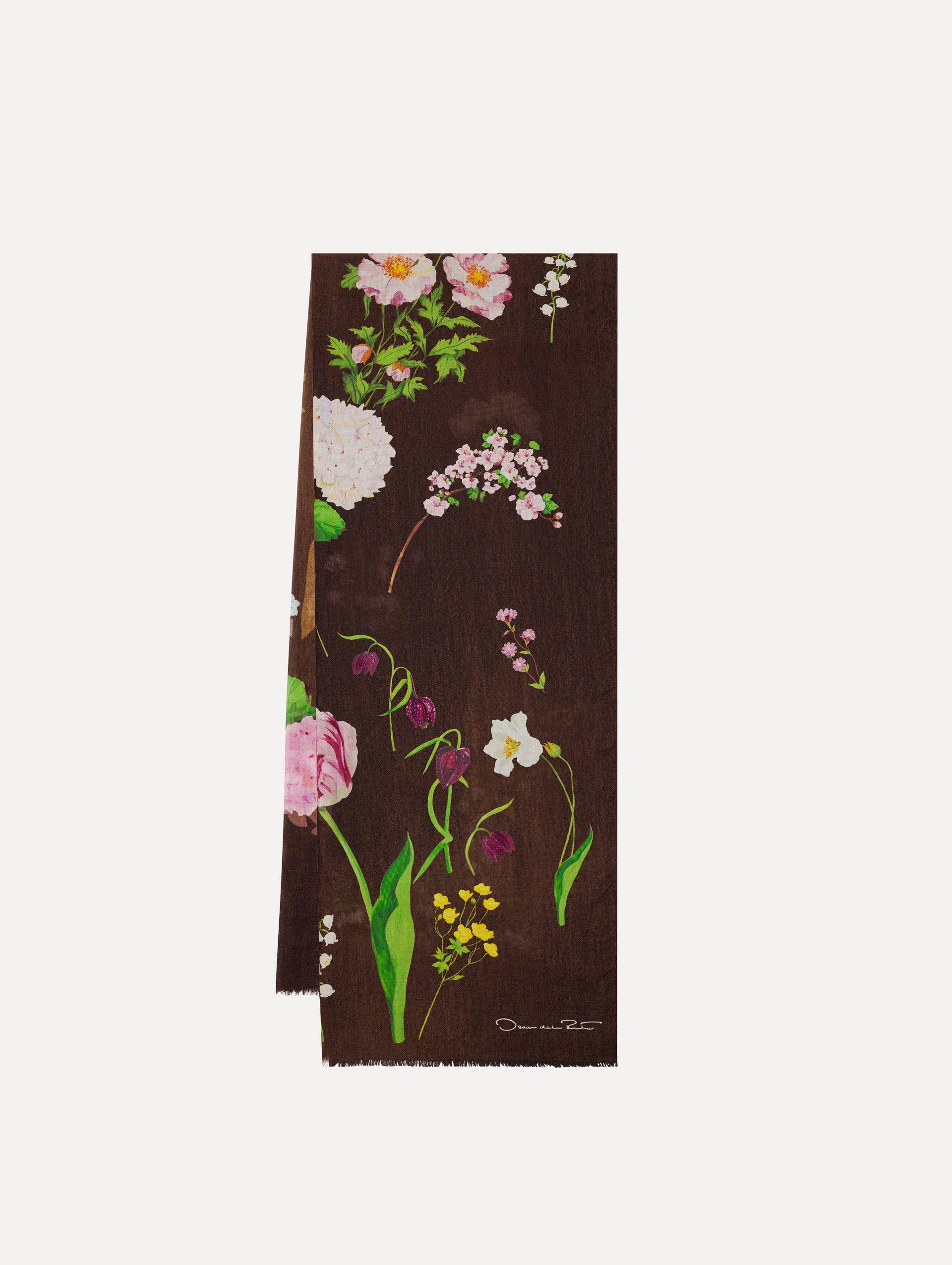 The model is wearing the mixed botanical scarf with an all-over floral print in the color brown. 