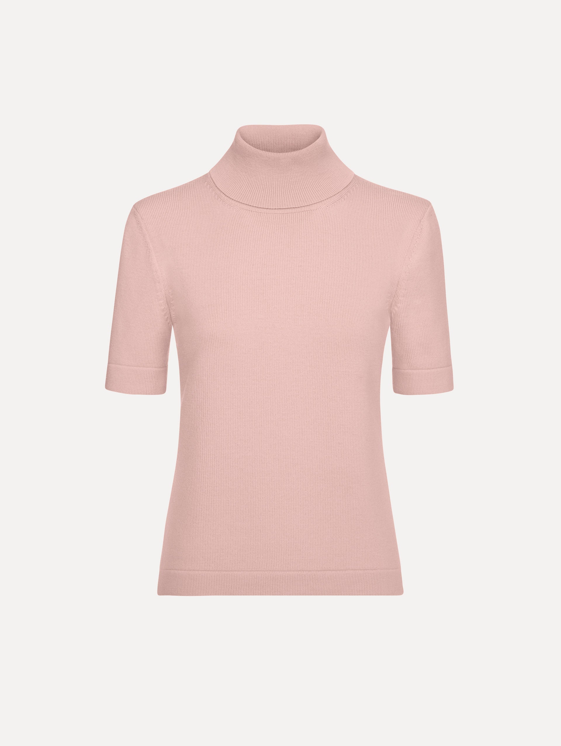 The model is wearing the turtleneck wool short-sleeve pullover with a fold-over neckline in the color blush. 