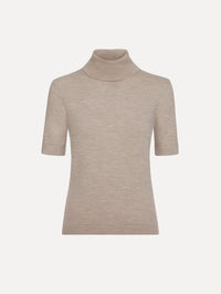 The model is wearing the turtleneck wool short-sleeve pullover with a fold-over neckline in the color dark oat.