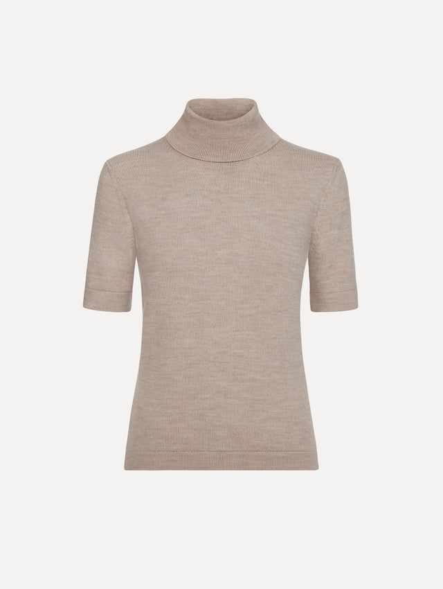 The model is wearing the turtleneck wool short-sleeve pullover with a fold-over neckline in the color dark oat.