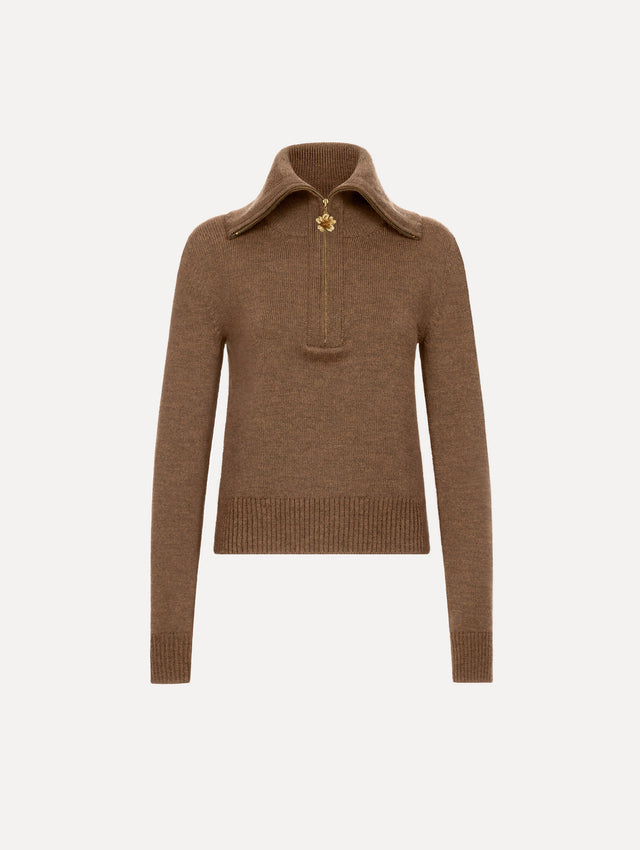 The model is wearing the double collar double zip pullover in the color brown with a quarter-zip closure.