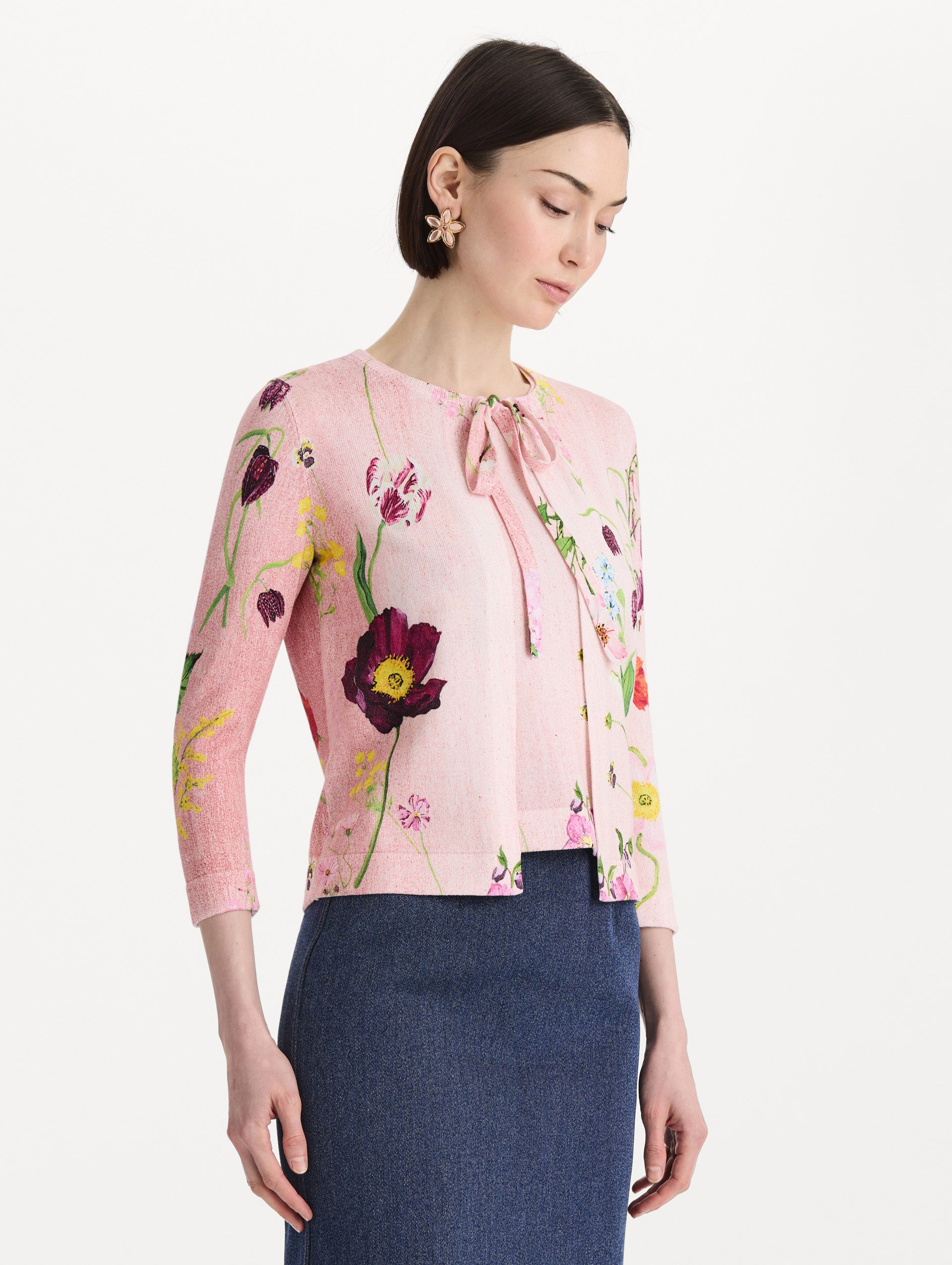 The model is wearing the mixed botanical tie-neck cardigan with an all-over floral print in blush multi. Side view.