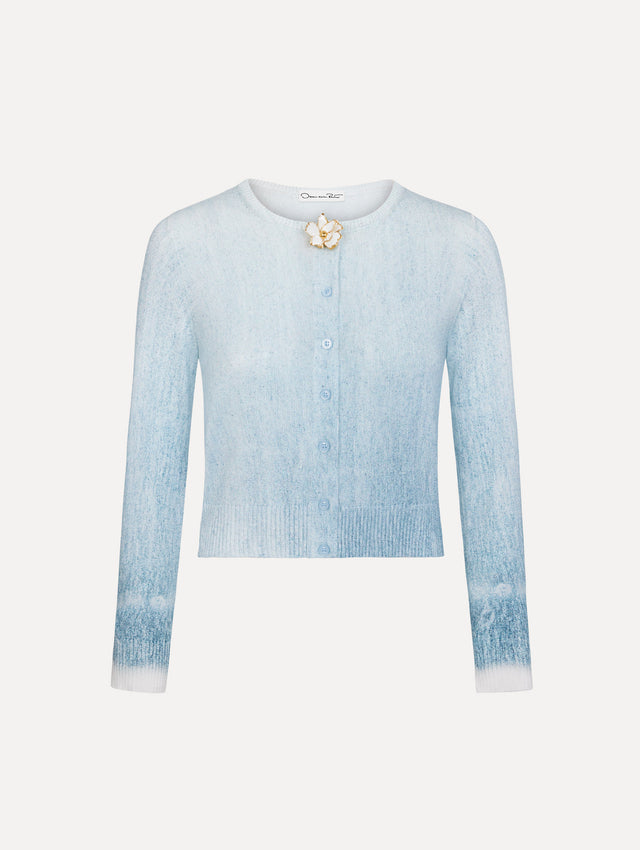 The model is wearing the ombré button-detailed cardigan in the color blue with decorative button detailing.