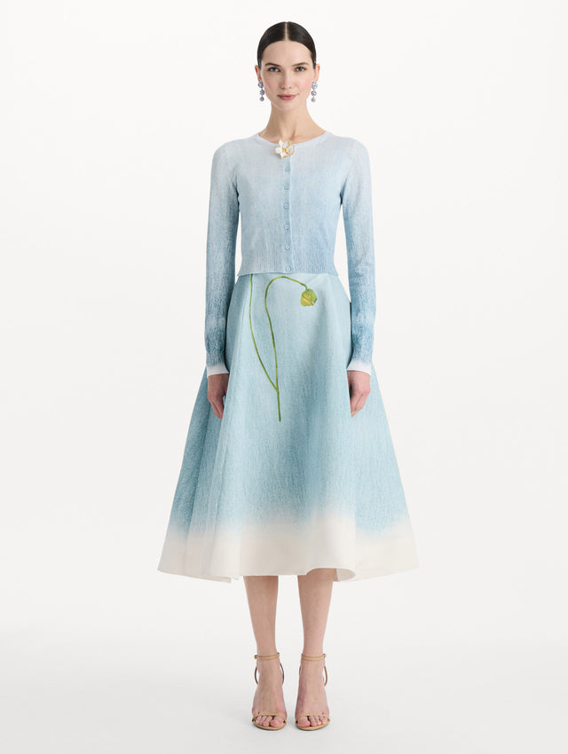 The model is wearing the ombré button-detailed cardigan in the color blue with decorative button detailing. Front view.