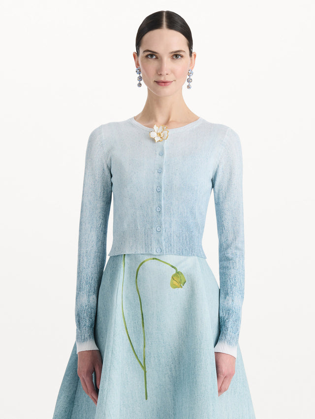 The model is wearing the ombré button-detailed cardigan in the color blue with decorative button detailing. Front view.