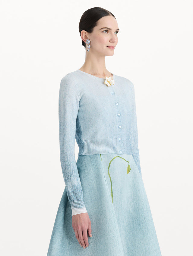 The model is wearing the ombré button-detailed cardigan in the color blue with decorative button detailing. Side view.