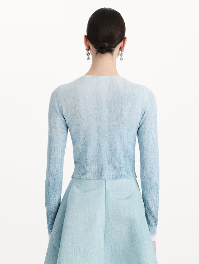 The model is wearing the ombré button-detailed cardigan in the color blue with decorative button detailing. Back view.