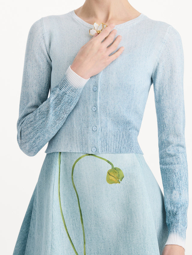 The model is wearing the ombré button-detailed cardigan in the color blue with decorative button detailing. Zoom view.