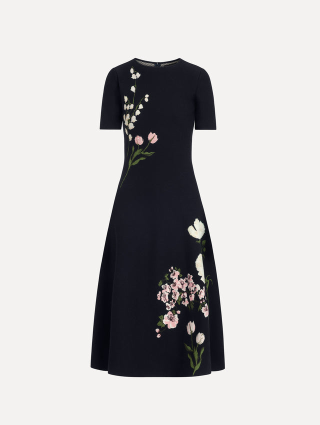 The model is wearing the mixed botanical jacquard dress with long sleeves in the color navy.