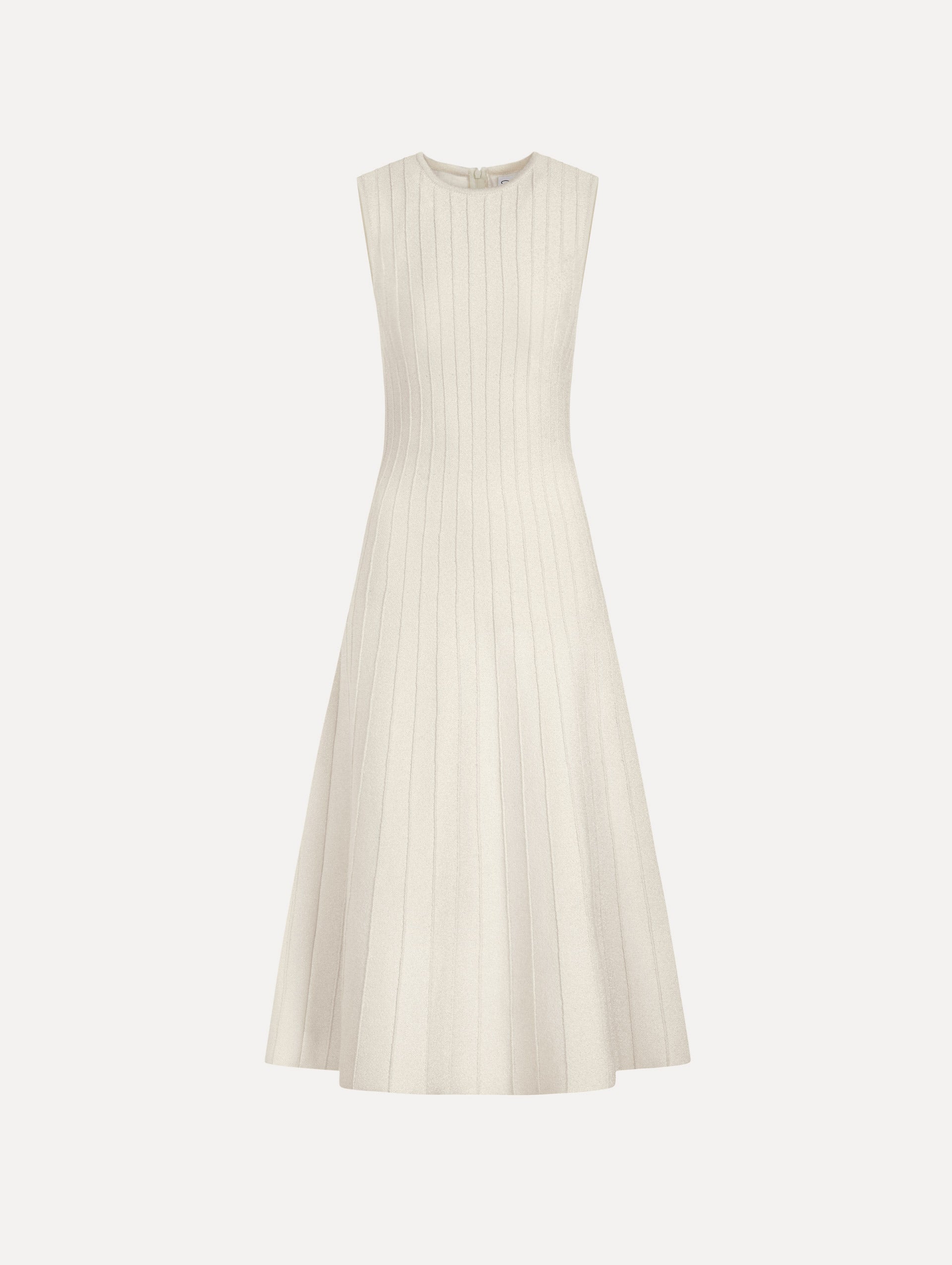 The model is wearing the ottoman knit dress in the color ivory with metallic sparkle yarn detailing.