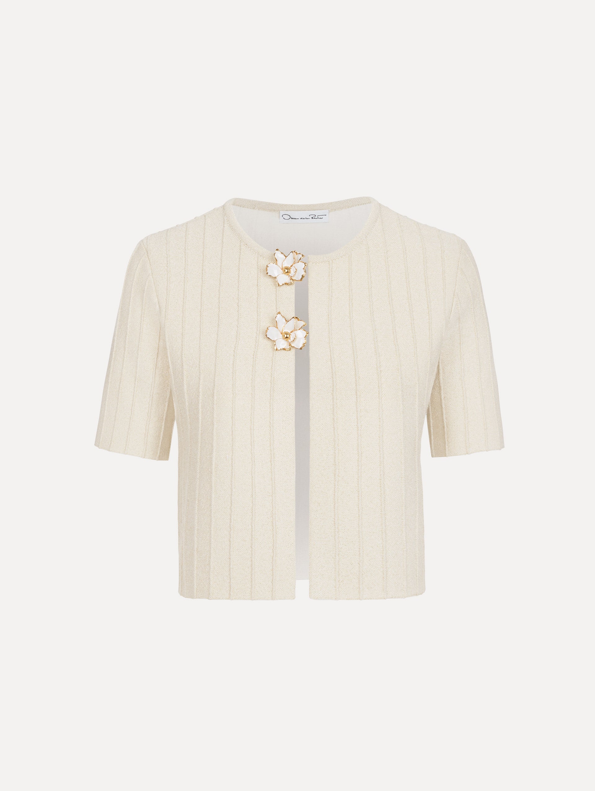 The model is wearing the ottoman cropped cardigan with sparkle yarn detailing in the color ivory. 