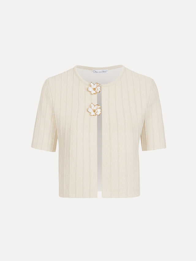 The model is wearing the ottoman cropped cardigan with sparkle yarn detailing in the color ivory. 