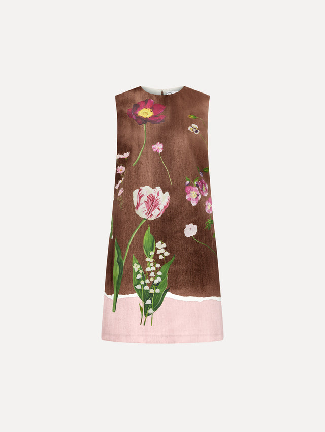 The model is wearing the mixed botanical shift dress with a border print and a sleeveless silhouette.