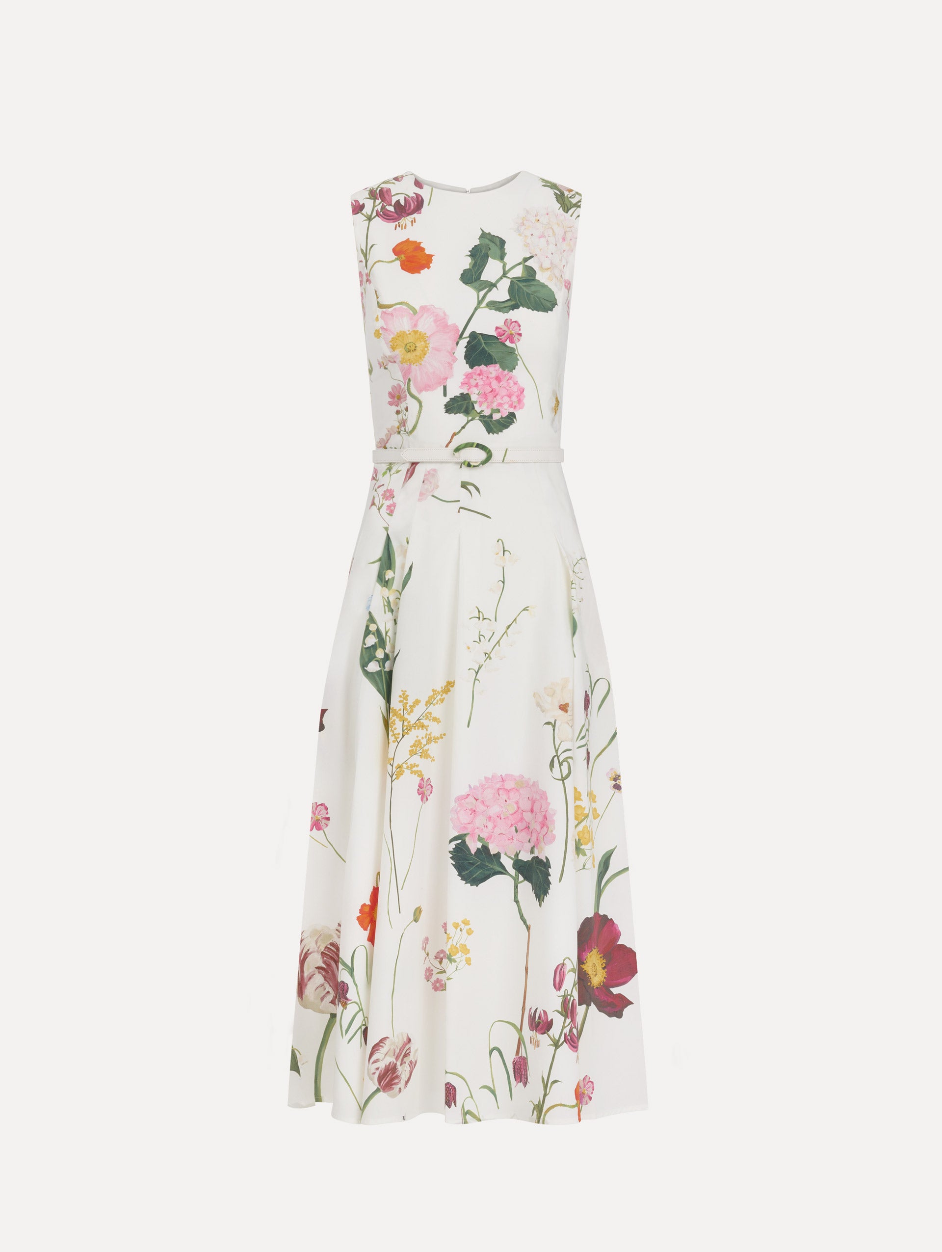 The model is wearing the mixed botanical cotton poplin sleeveless dress with an all-over floral print in white multi. 