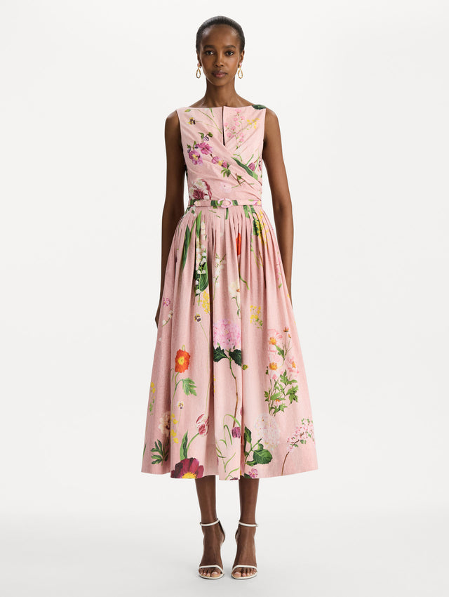 The model is wearing the mixed botanical cotton poplin draped dress with waist detailing and an all-over floral print in blush multi. Front view. 