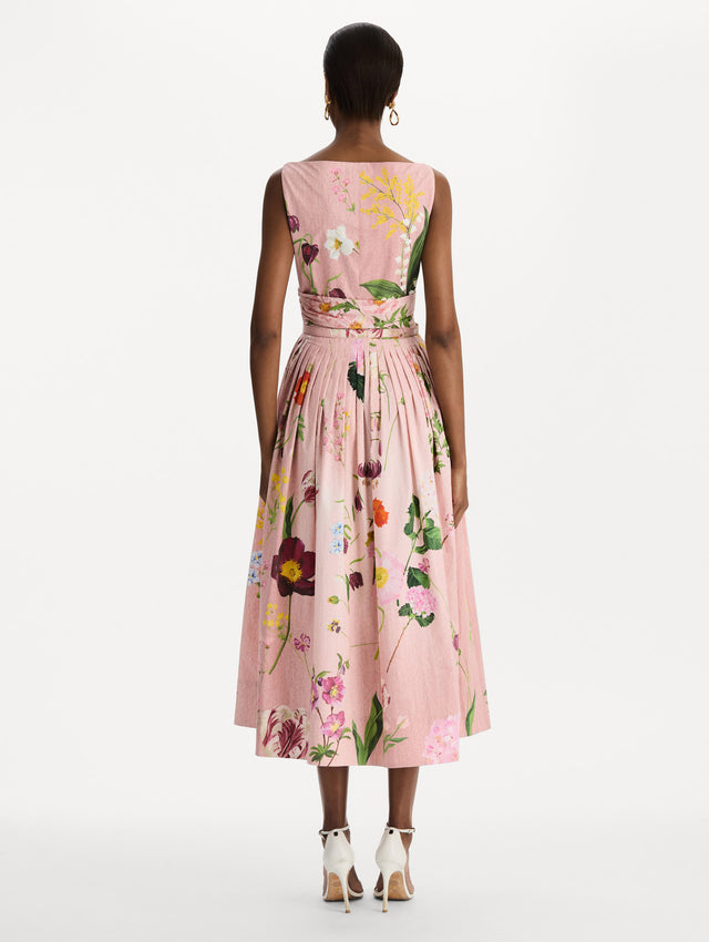 The model is wearing the mixed botanical cotton poplin draped dress with waist detailing and an all-over floral print in blush multi. Back view. 
