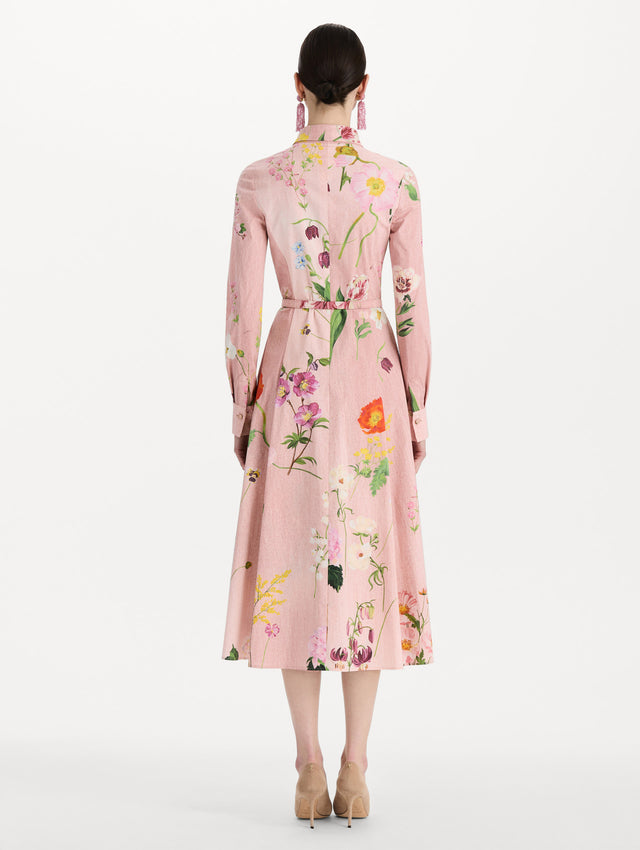 The model is wearing the mixed botanical cotton poplin dress with a collared neckline, long sleeves, and an all-over floral print in blush multi. Back view. 