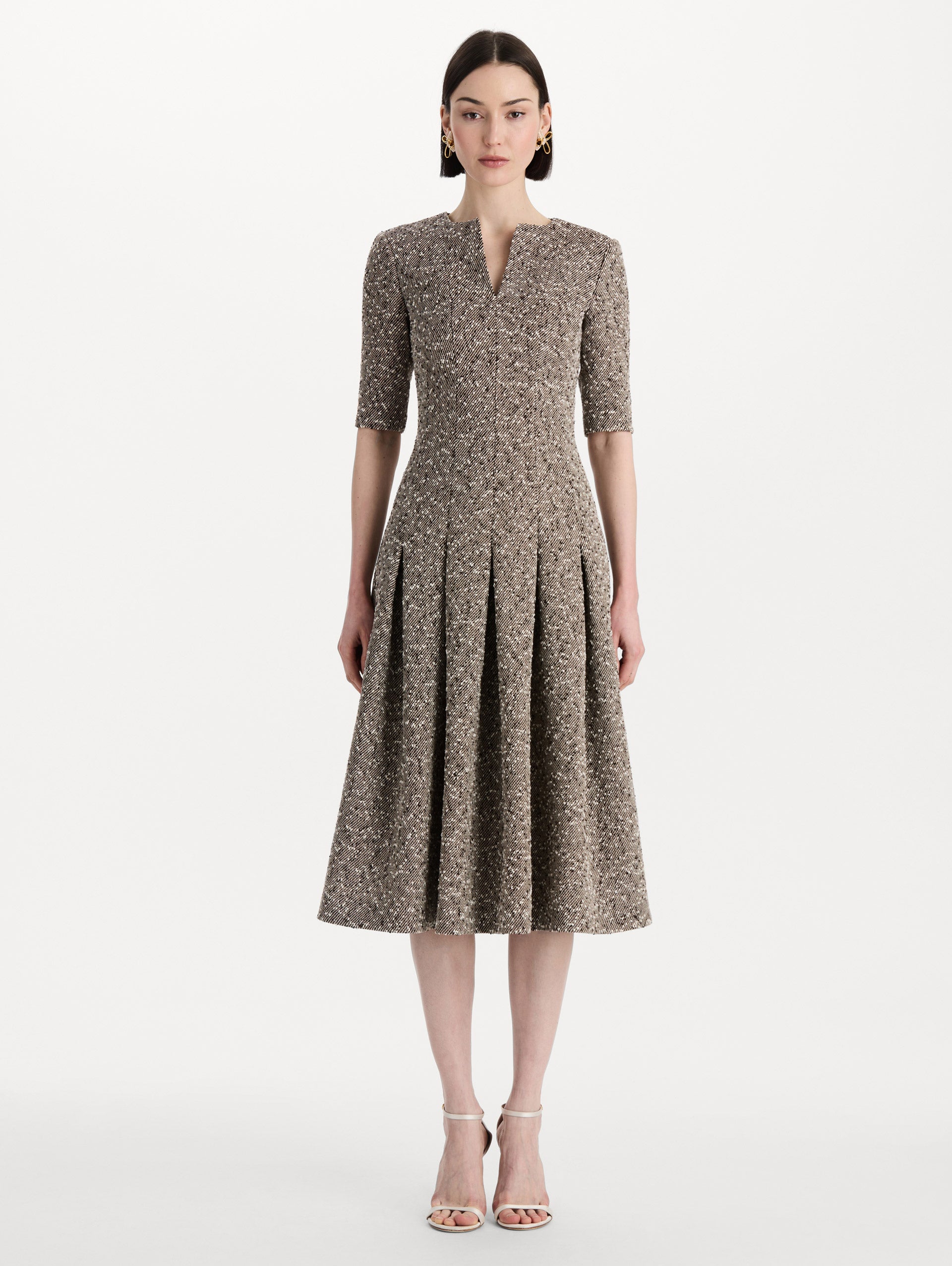 The model is wearing the Slub Wool Tweed Gauze Dress with midi sleeves in an ivory and brown palette. Front view. 