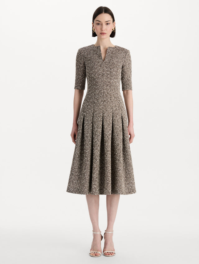 The model is wearing the Slub Wool Tweed Gauze Dress with midi sleeves in an ivory and brown palette. Front view. 