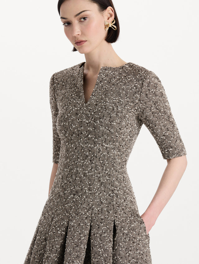 The model is wearing the Slub Wool Tweed Gauze Dress with midi sleeves in an ivory and brown palette. Zoom view. 