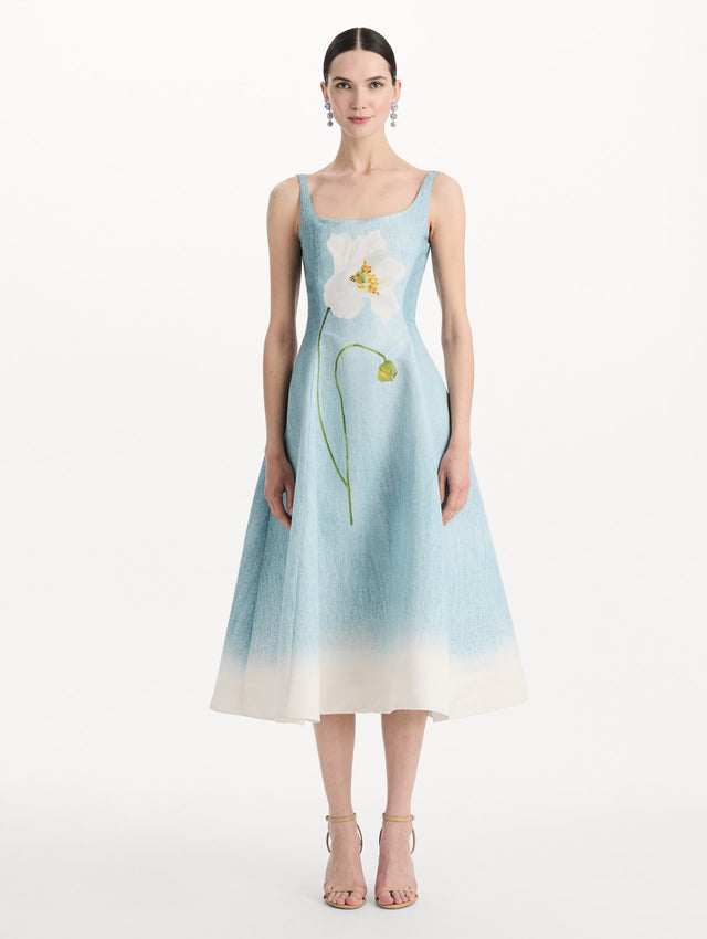 The model is wearing the ombré peony faille dress with a sleeveless scoop neckline in white and blue. Front view. 