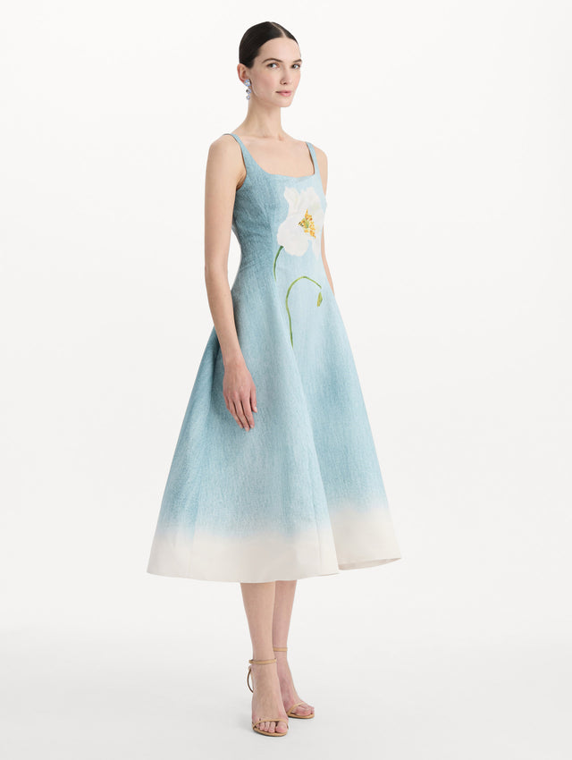 The model is wearing the ombré peony faille dress with a sleeveless scoop neckline in white and blue. Side view. 