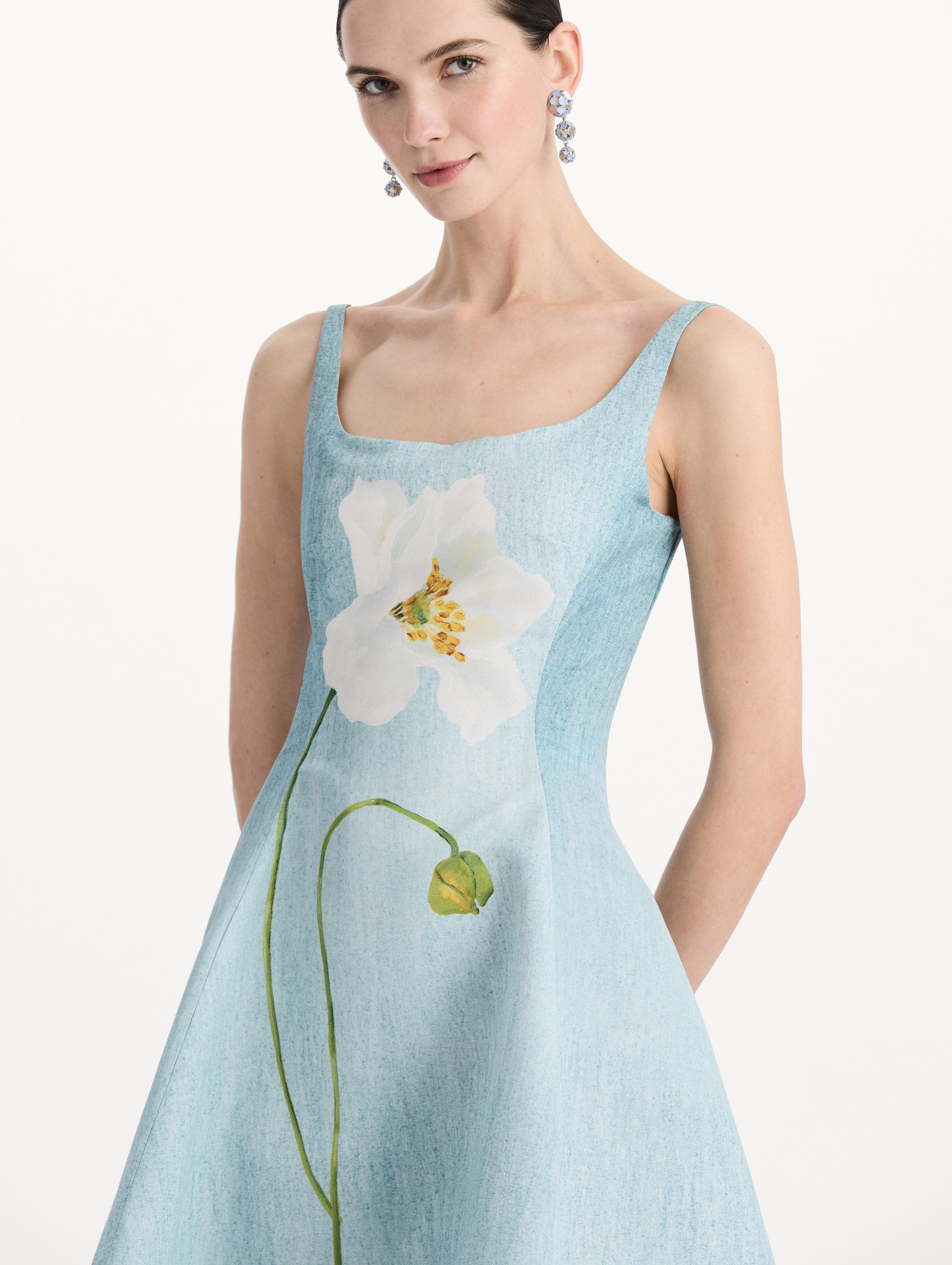 The model is wearing the ombré peony faille dress with a sleeveless scoop neckline in white and blue. Zoom view. 